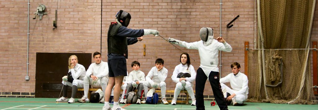 Junior fencers being coaches on a fencing course